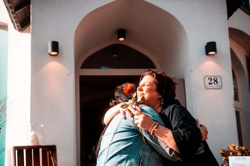 Blumen verteilen am Weltfrauentag. Umarmung